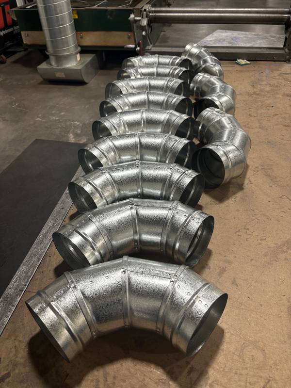 Row of spiral duct elbows